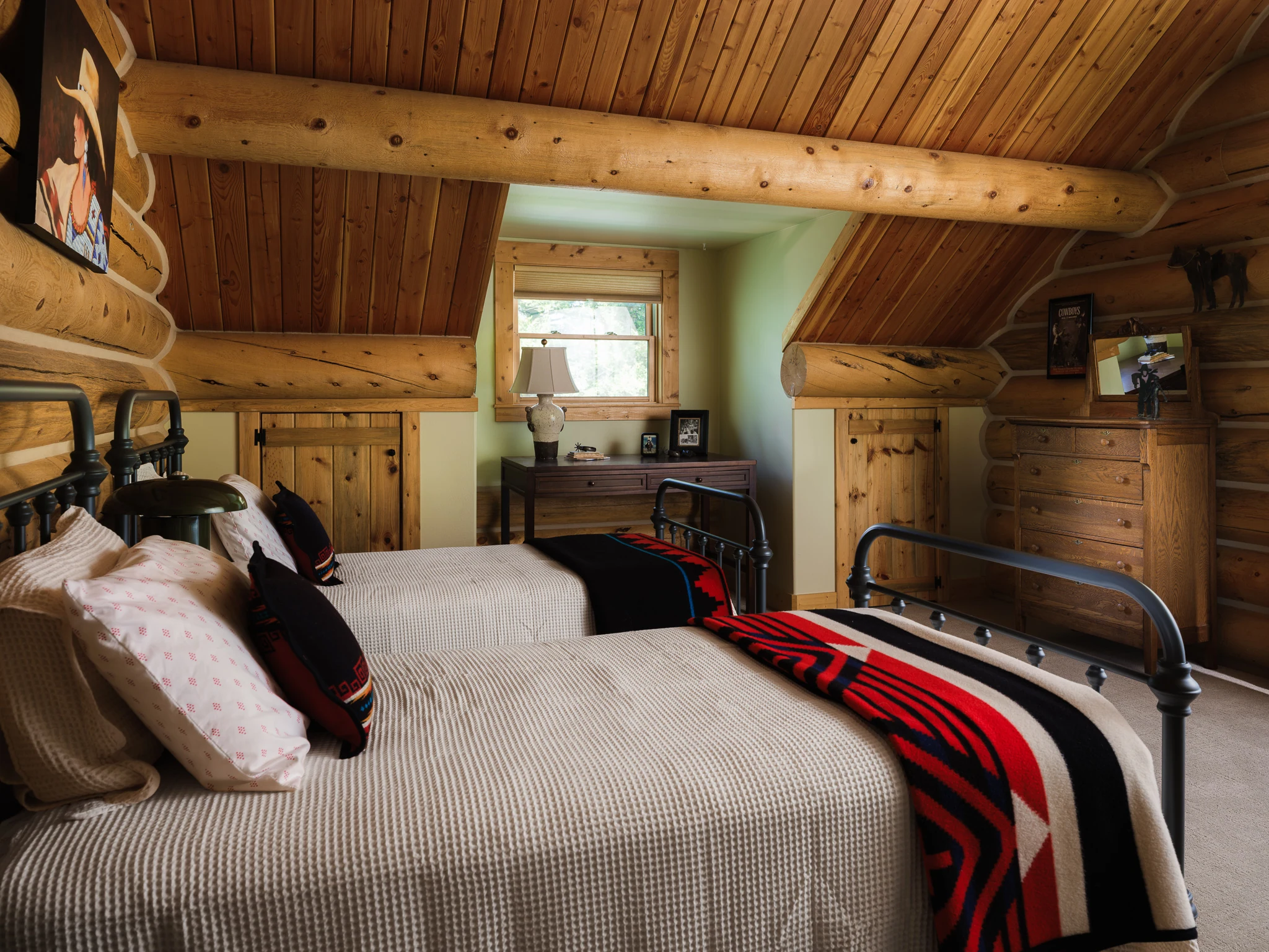Twin bedroom with iron bed frames and a Pendleton-style blanket — interior design photography Livingston Montana, Sam Schlauch Designs
